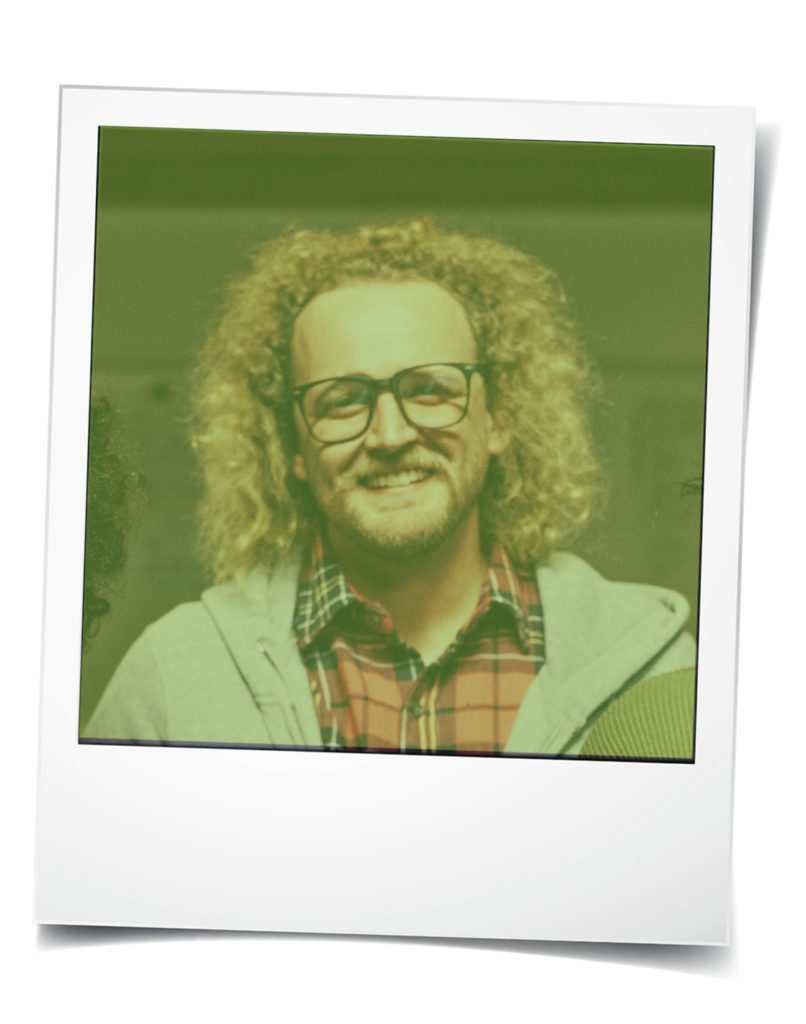 Polaroid-style photo of young white man with curly hair and glasses