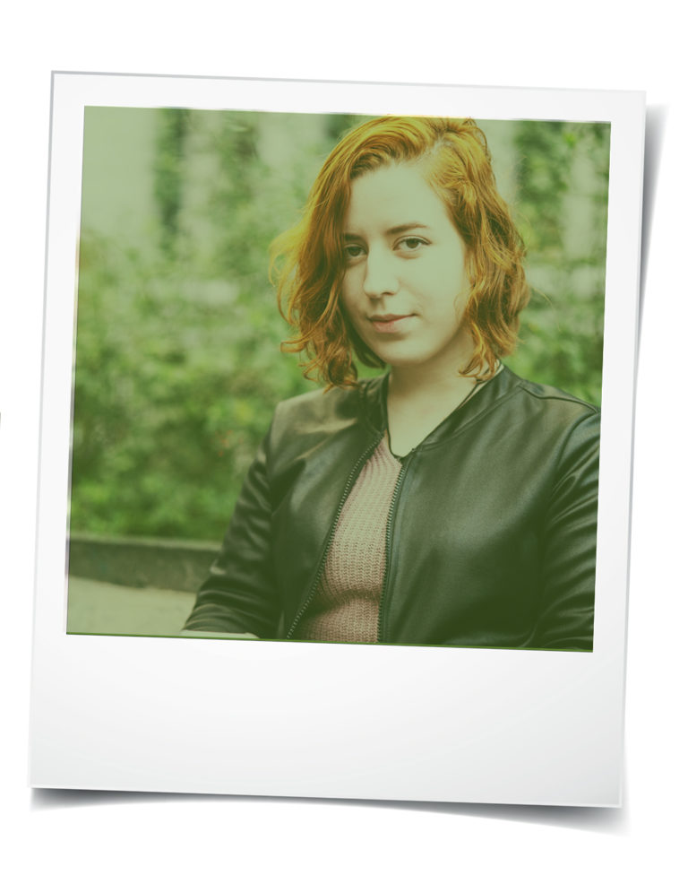 Polaroid-style photo of young white woman with short red hair
